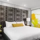 Hotel Arts Studio guestrooms king bed and decorative headboard