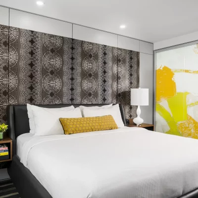 Hotel Arts Studio guestrooms king bed and decorative headboard